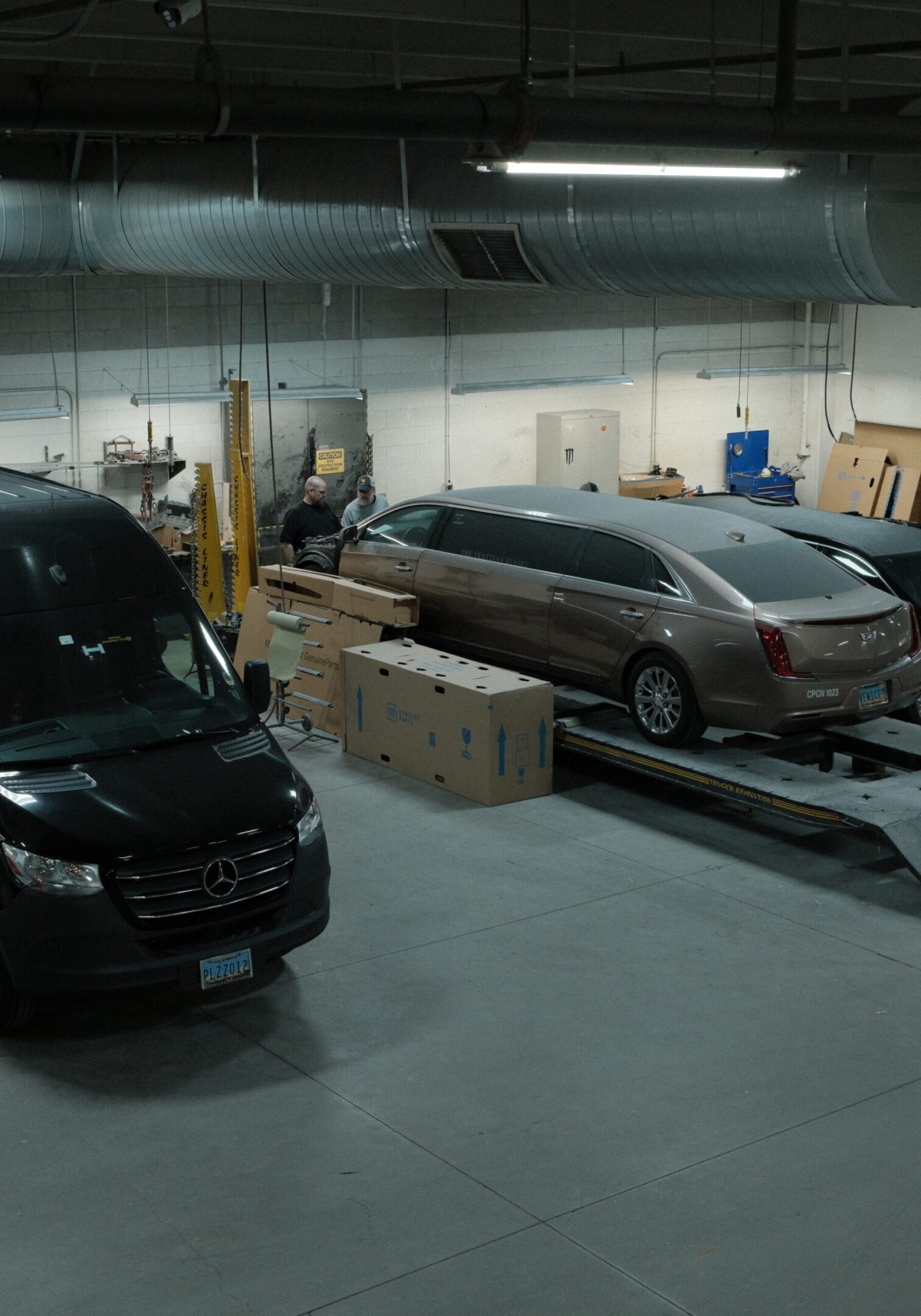 Garage with vehicles and equipment inside.